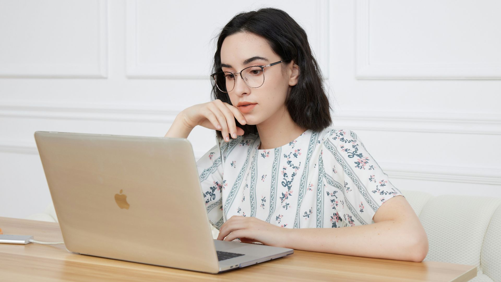 A woman sitting in front of a laptop computer