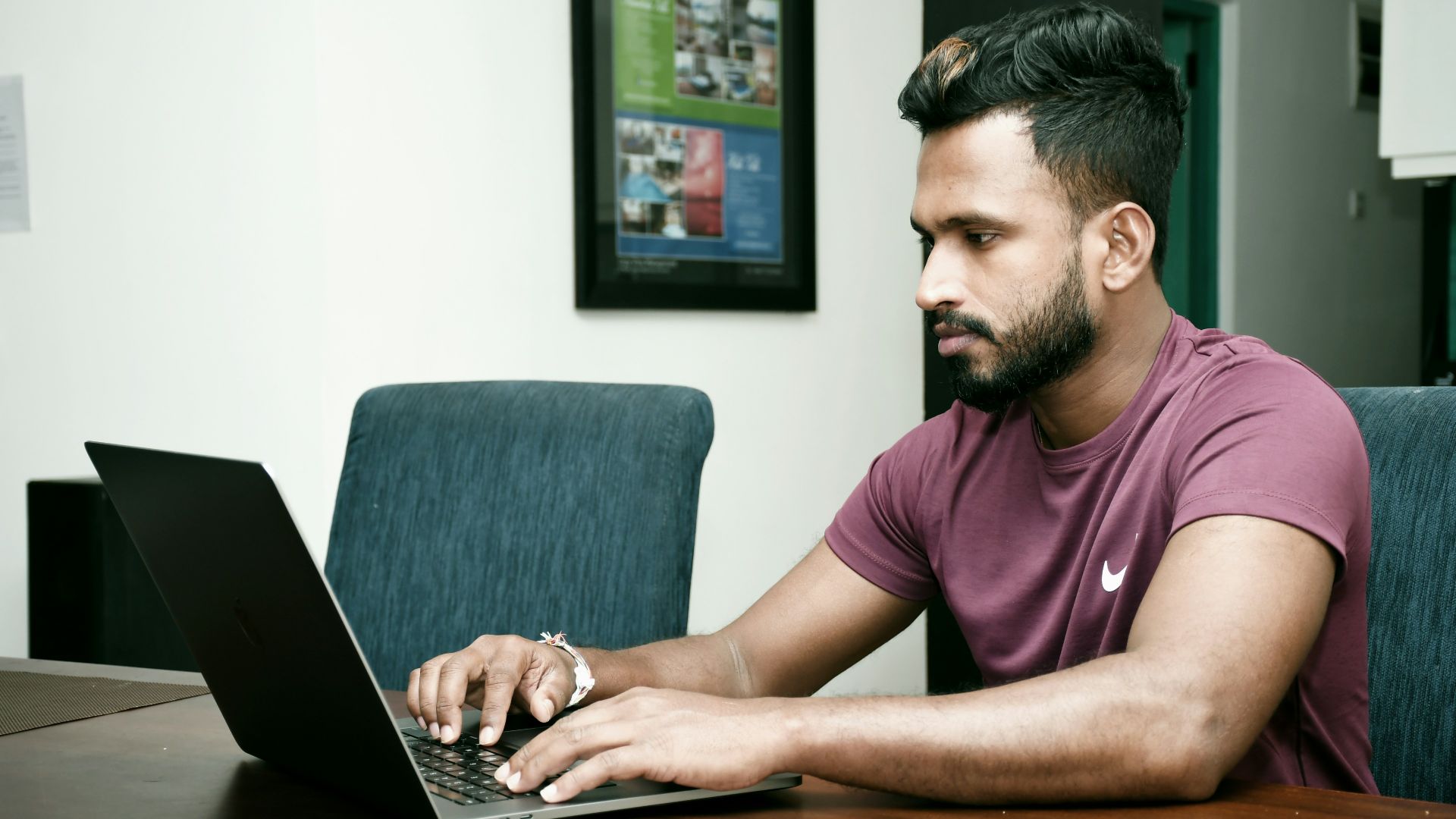 a man sitting in front of a laptop computer