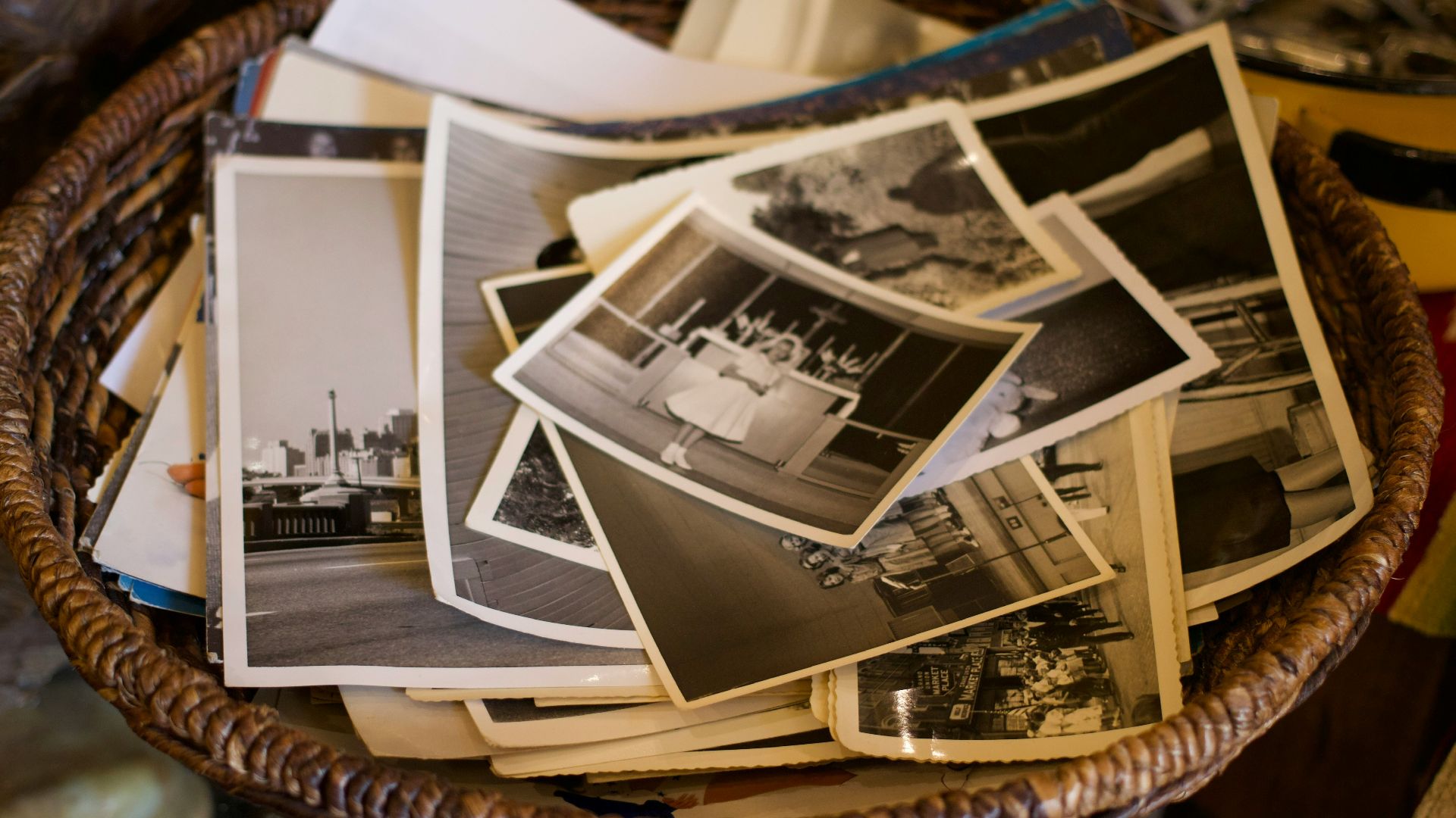 a basket filled with lots of pictures on top of a table