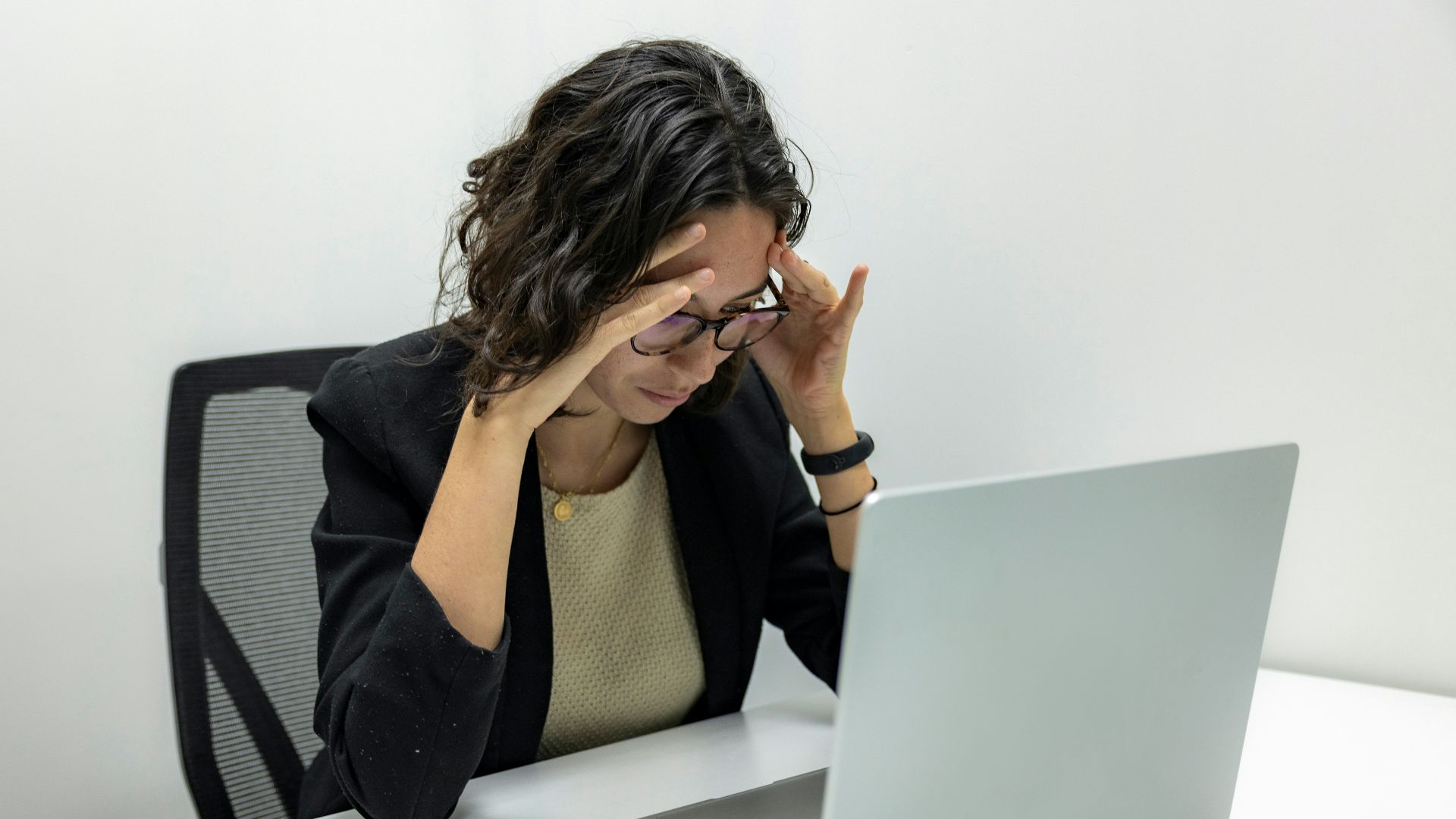 a woman sitting in front of a laptop computer