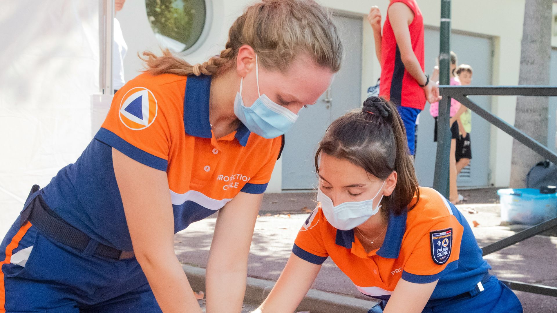 woman in blue t-shirt and blue pants holding baby