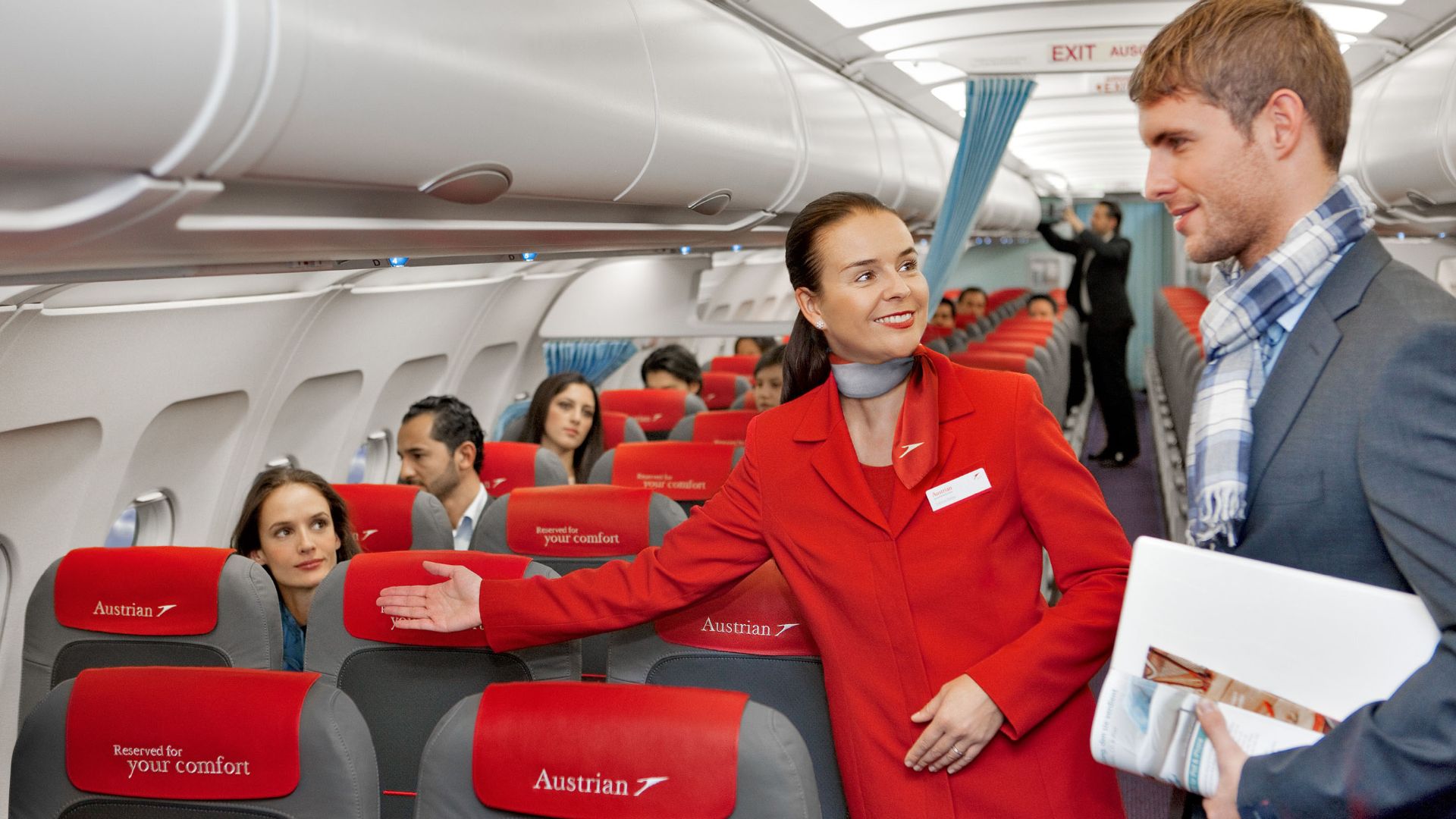 File:Austrian Airlines flight attendant and passenger.jpg