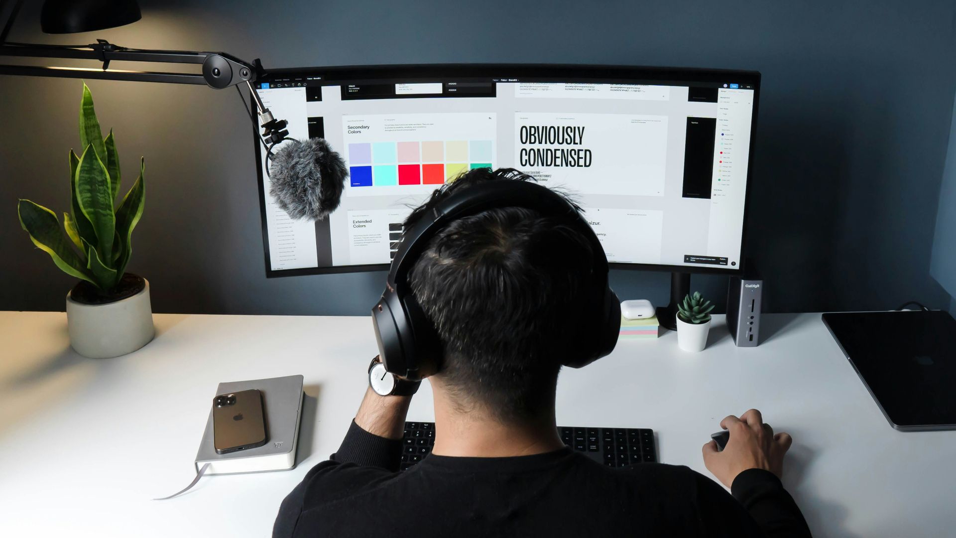 man in black shirt sitting in front of computer