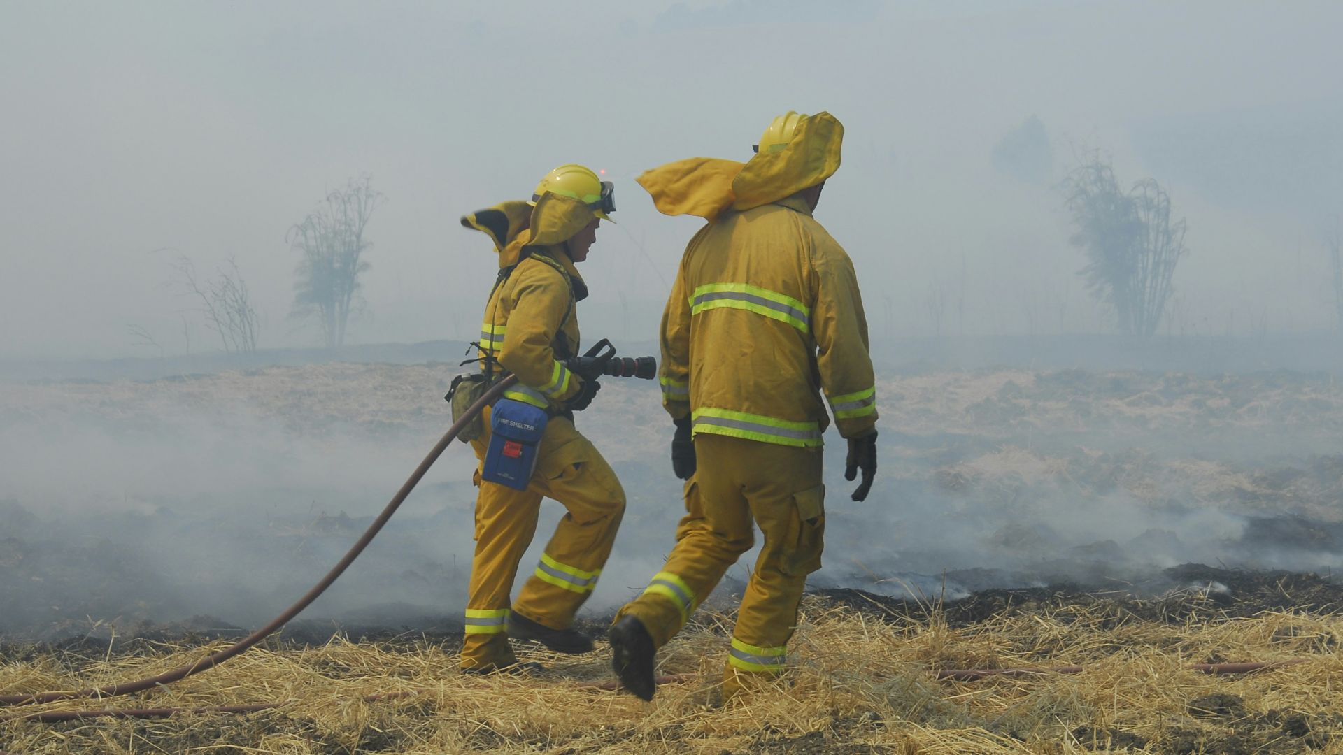 two people wearing bunker suits