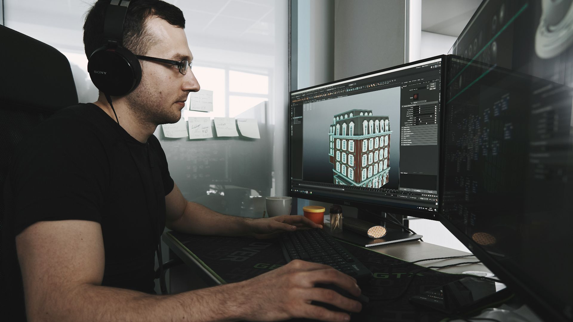 man in black tank top wearing black sunglasses using computer