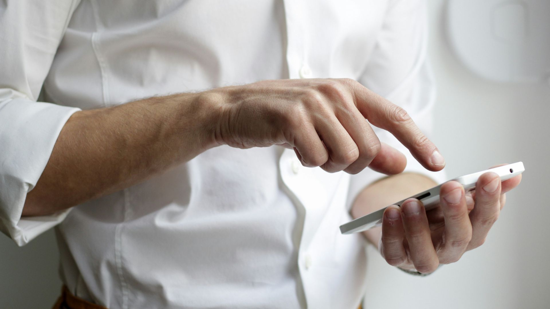 person holding white Android smartphone in white shirt