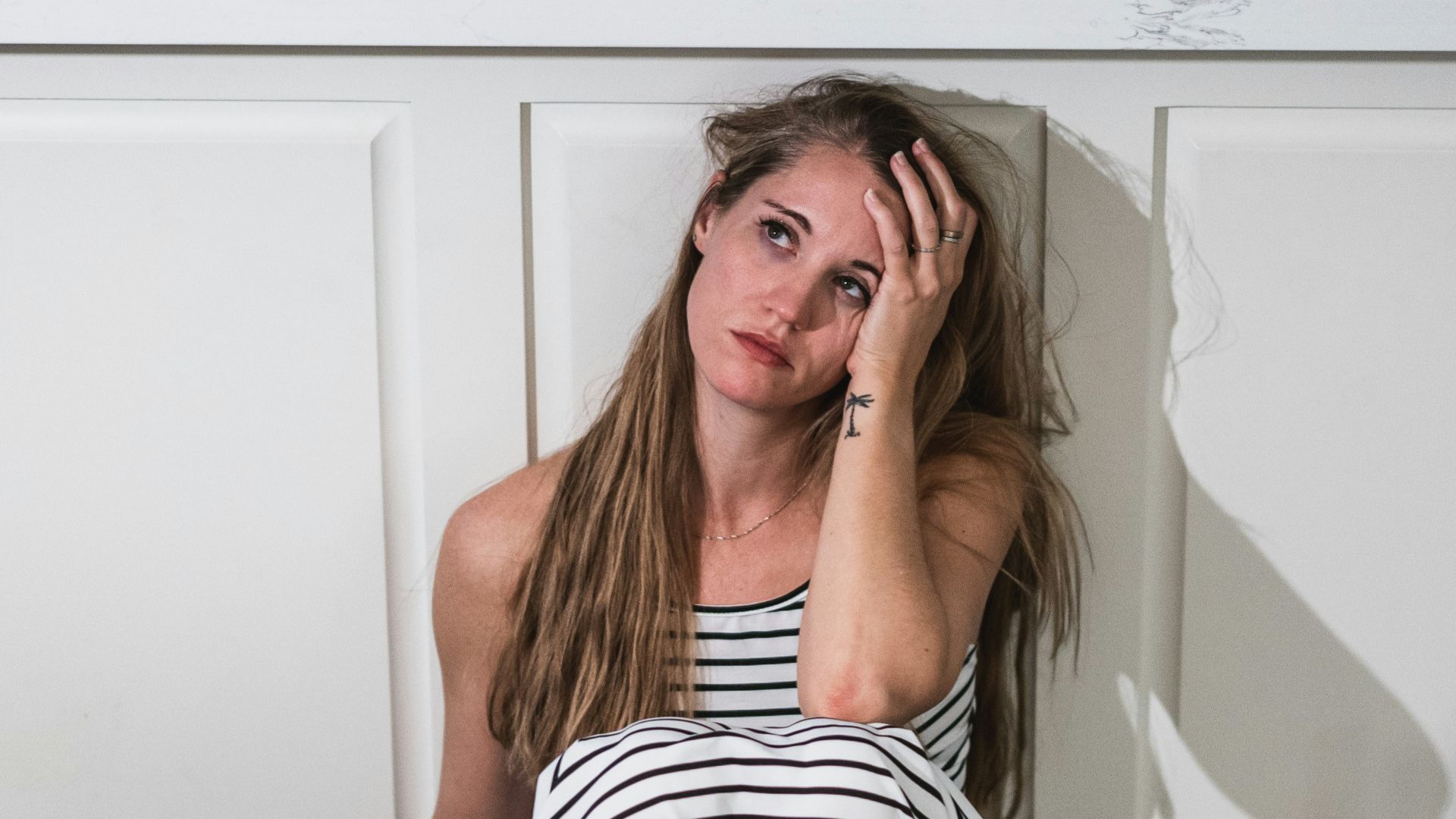 woman in black and white stripe dress holding wine glass