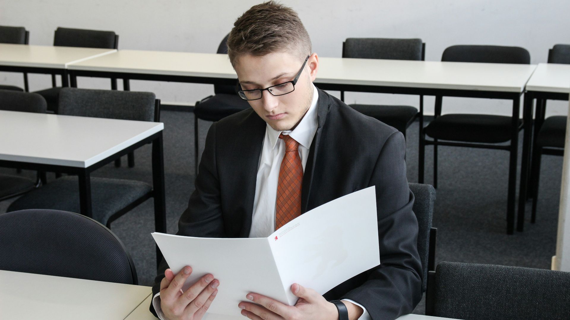 man holding folder in empty room