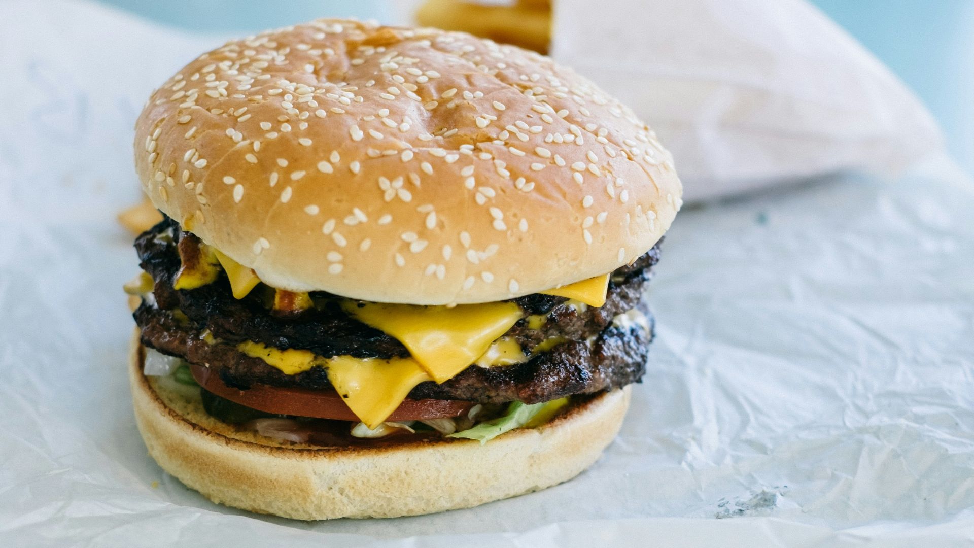 burger on white paper on white textile