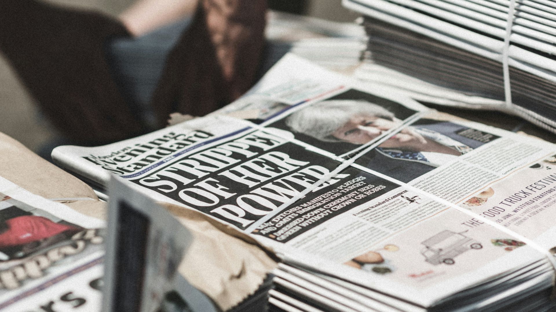 shallow focus photography of piles of newspapers
