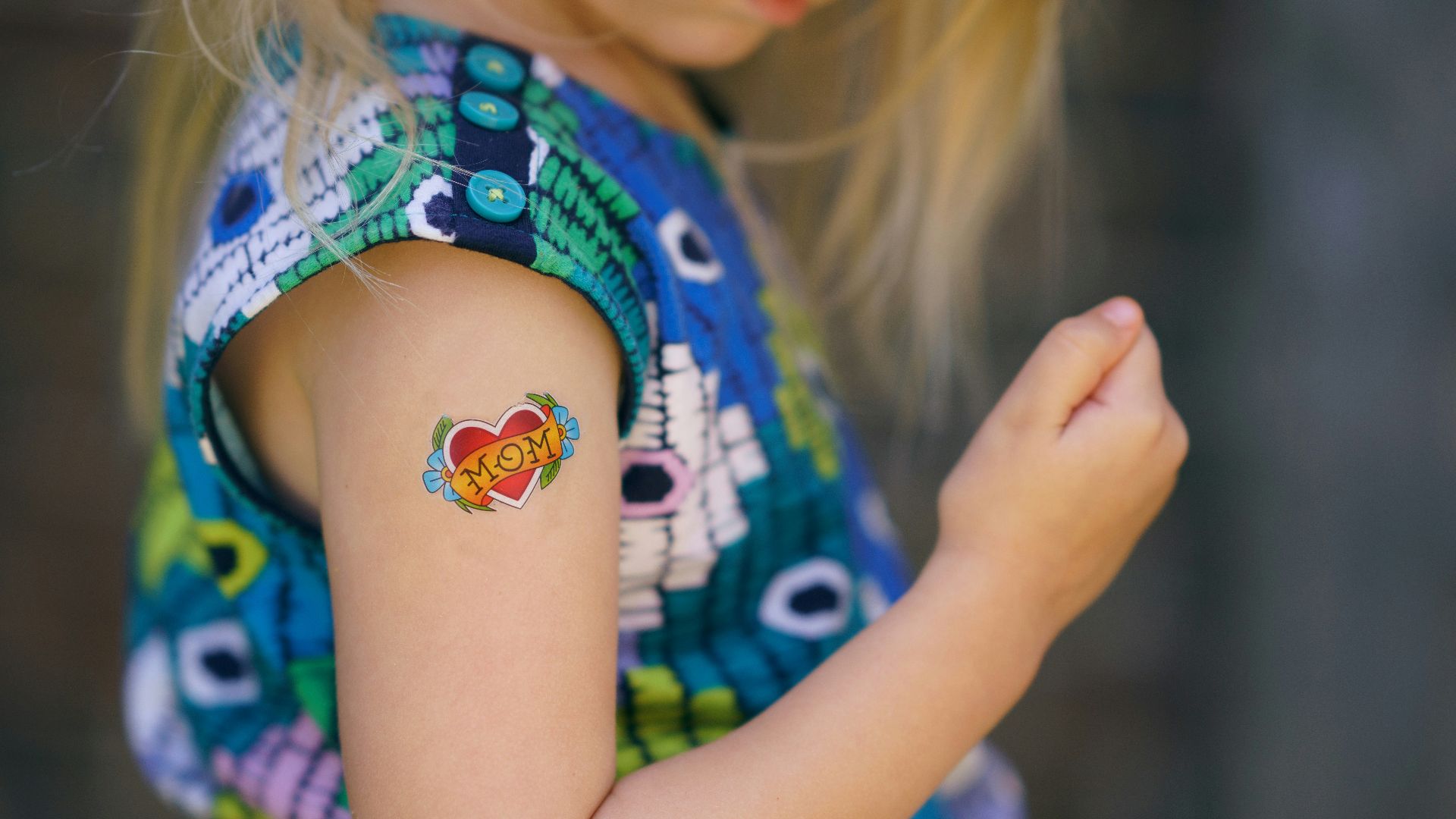 selective focus photo of girl with heart tattoo