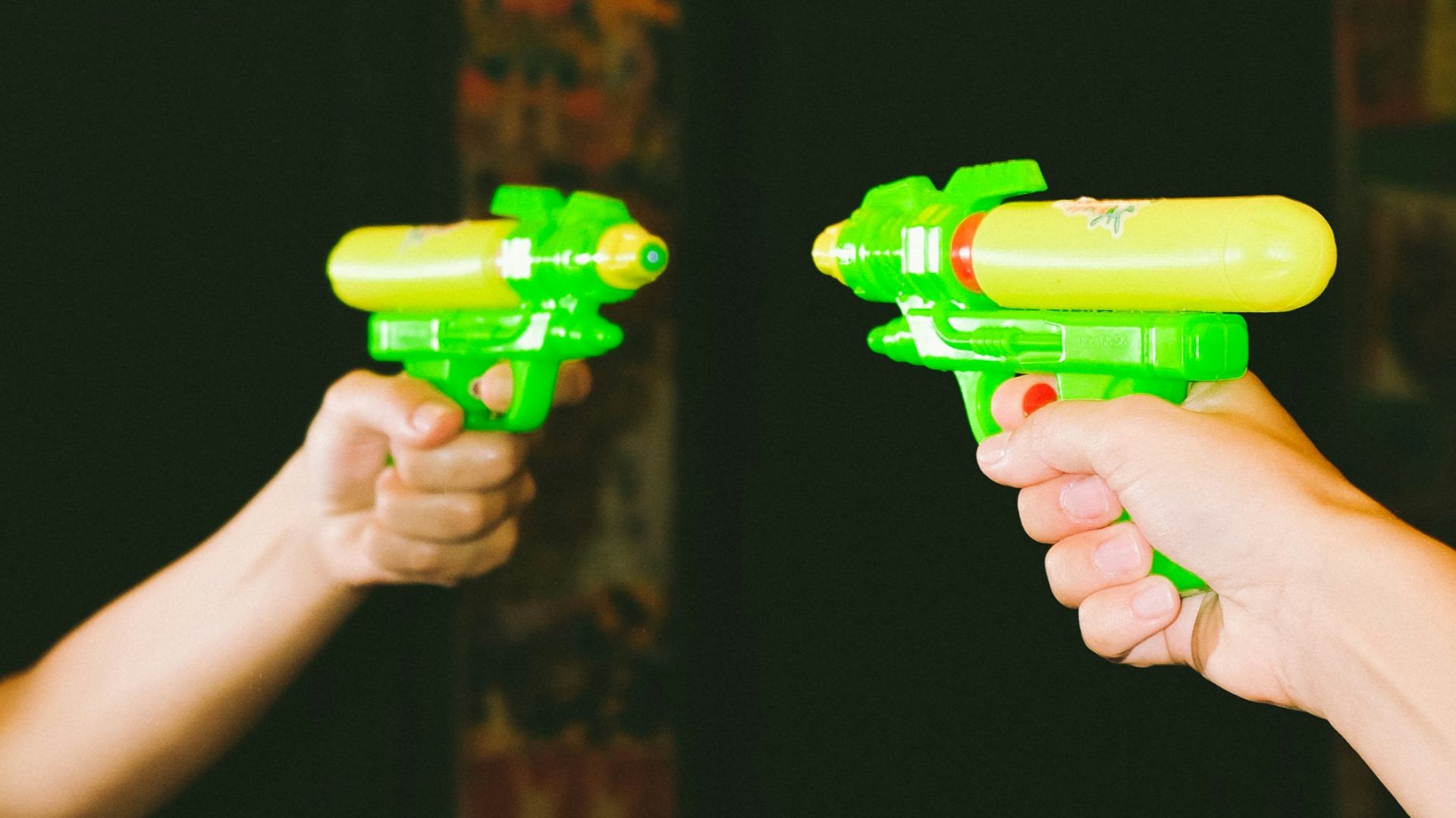 person holding green plastic toy