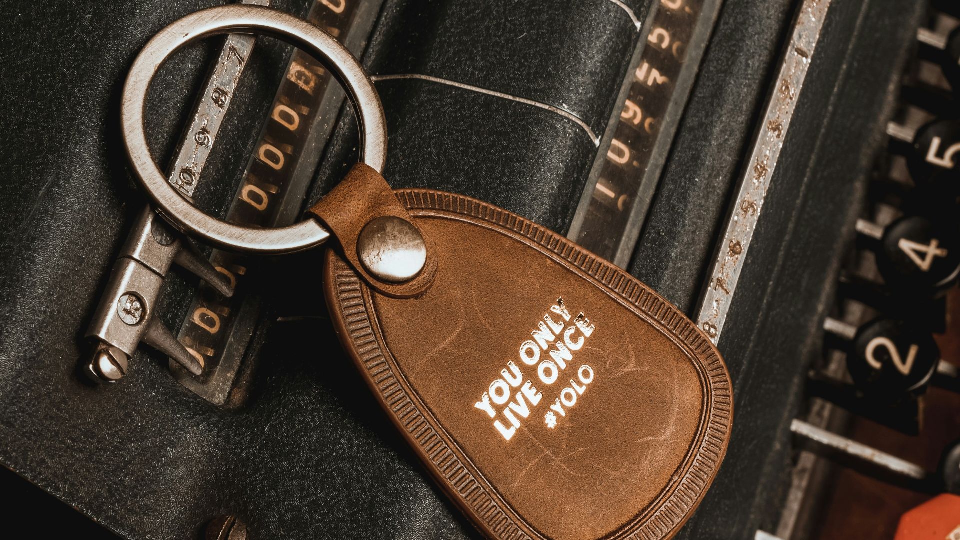 a keychain with a leather tag attached to it