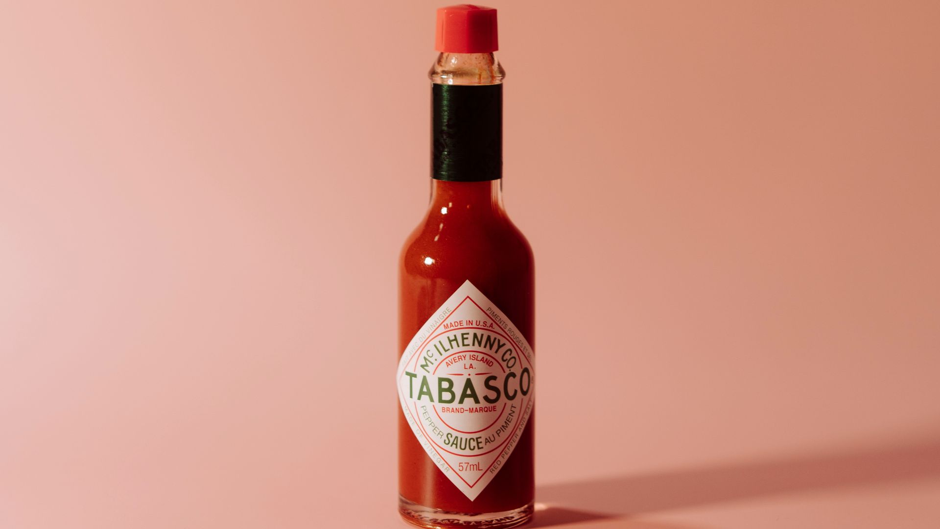 a bottle of tabbabata sauce on a pink background