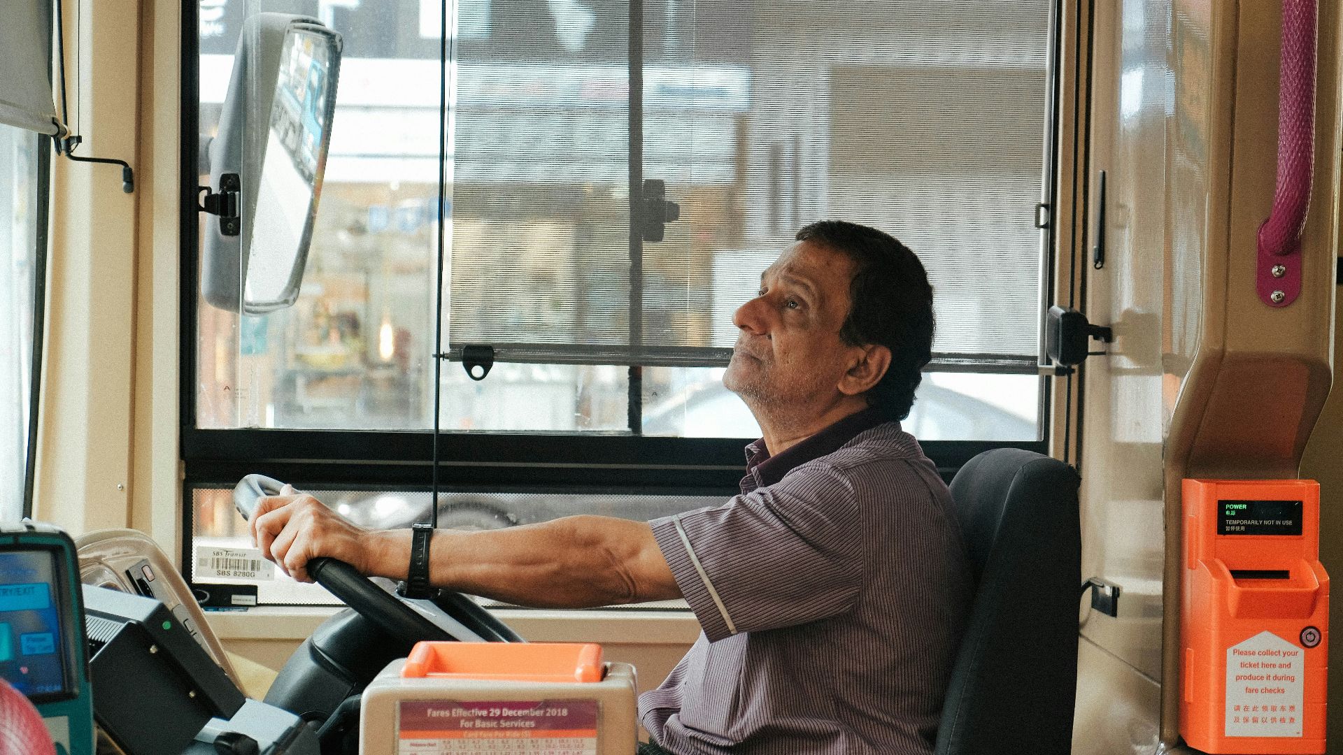 man in brown and white plaid button up shirt sitting on black office rolling chair