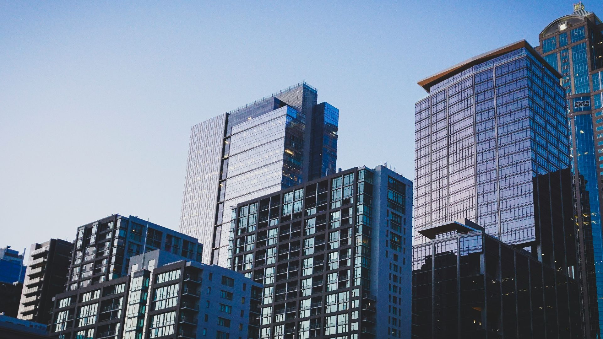 white and blue glass walled high rise building