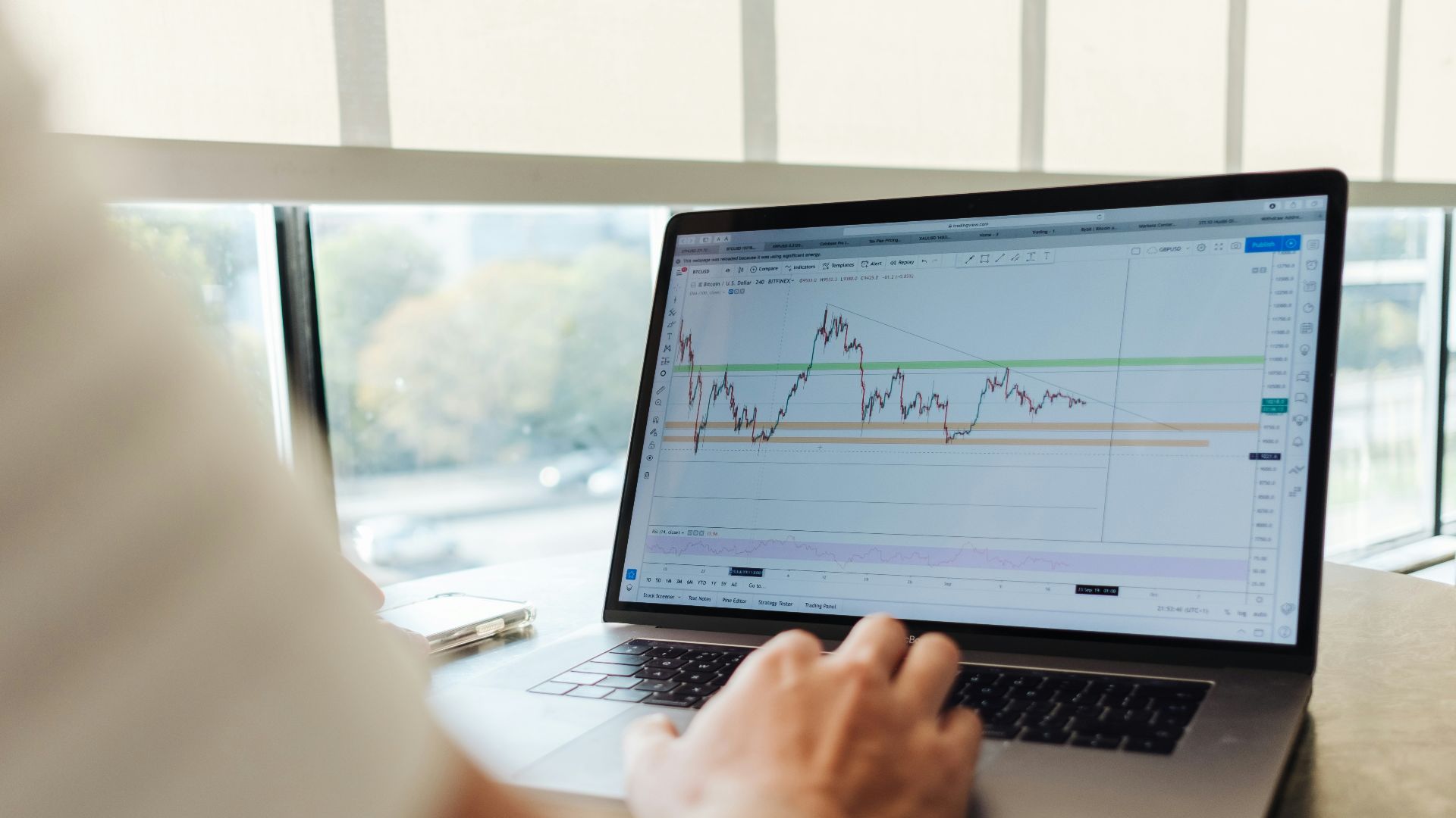 person using MacBook Pro on table