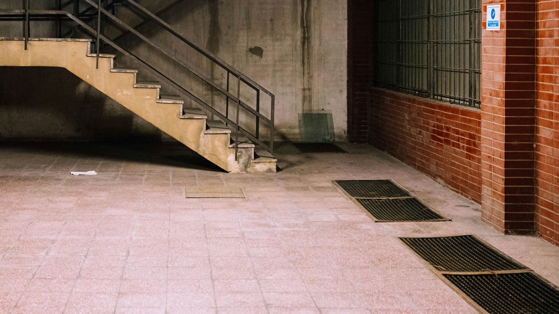 brown concrete staircase with stainless steel railings