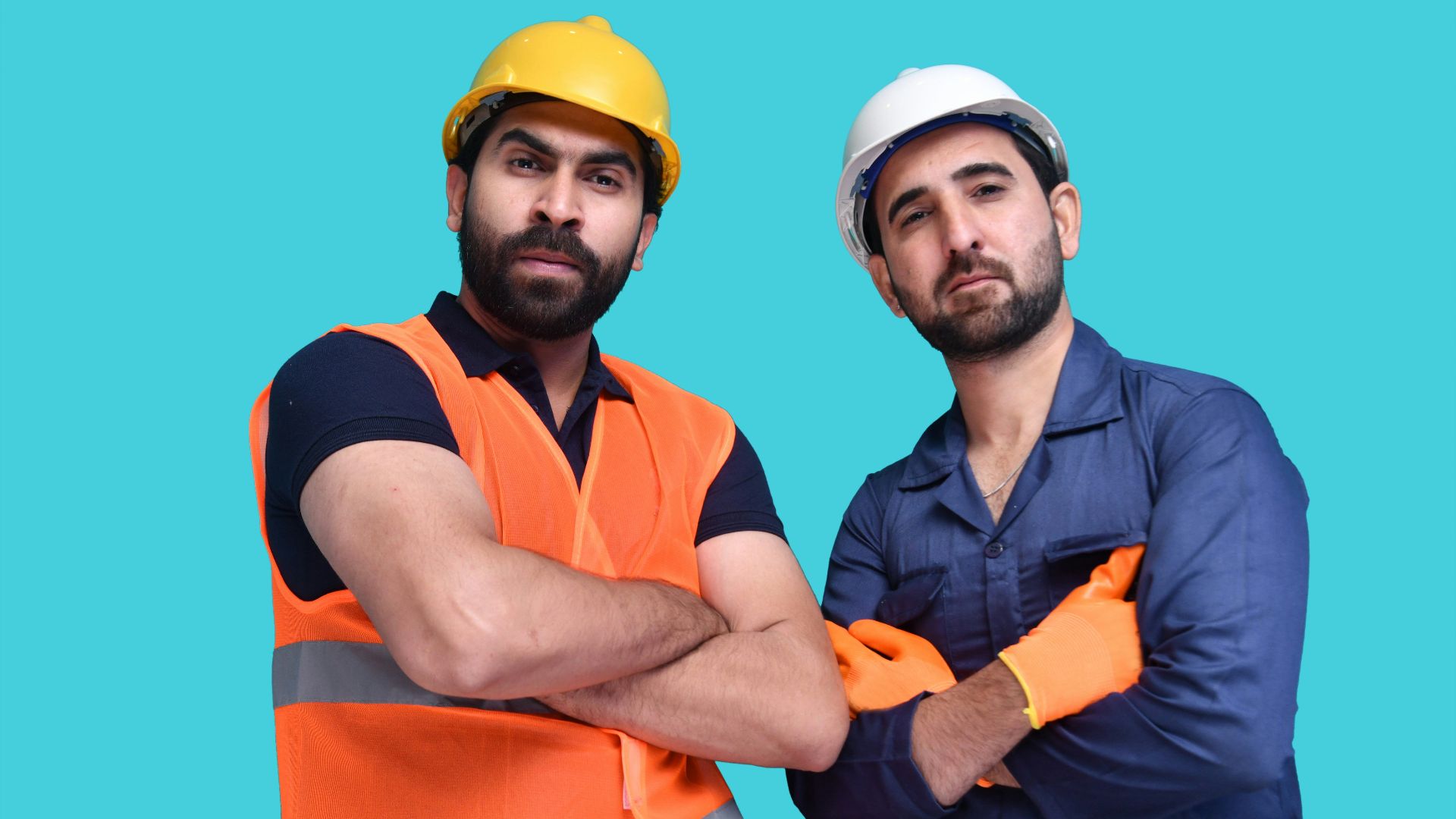 a couple of men wearing hard hats