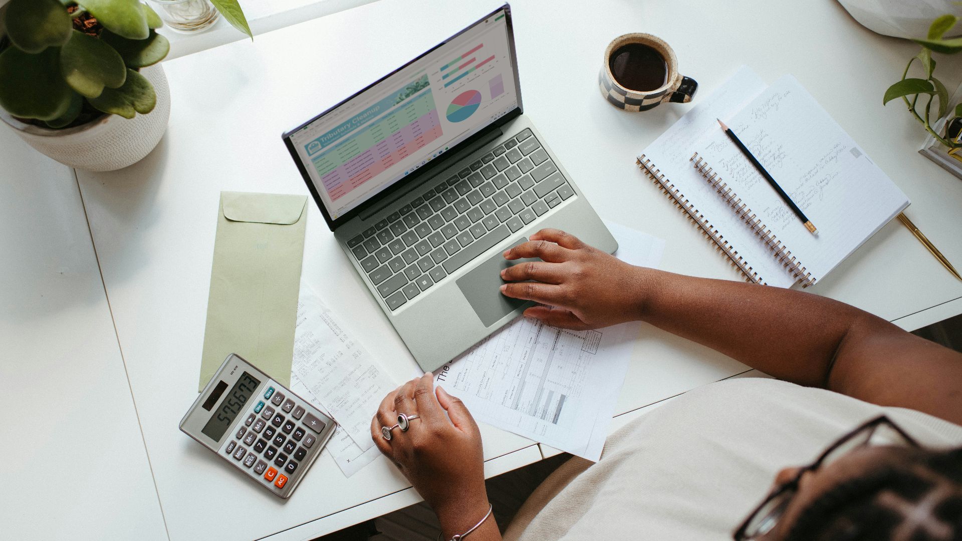 a person sitting at a table with a laptop