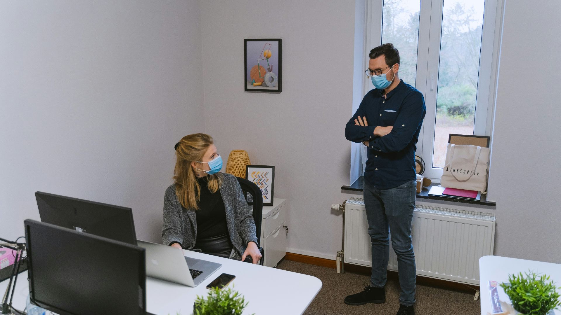woman in black long sleeve shirt standing beside woman in gray long sleeve shirt
