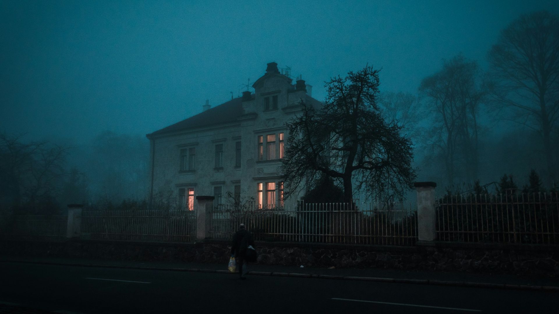 person walking towards house