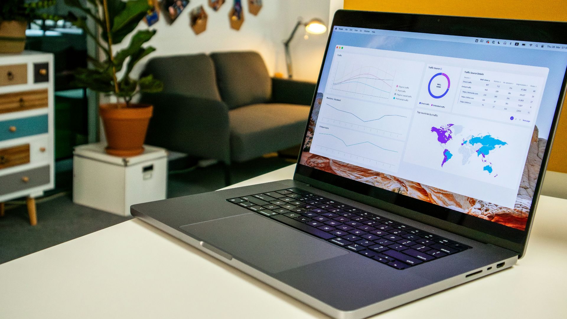 a laptop computer sitting on top of a white table