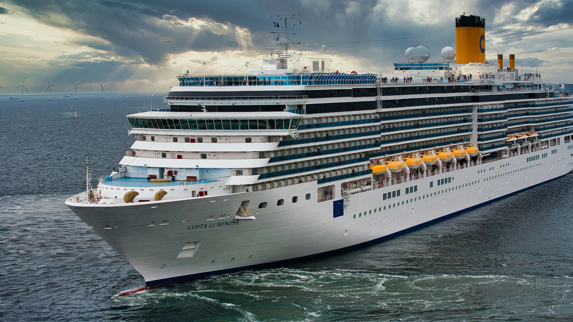 white cruise ship on sea under white clouds and blue sky during daytime