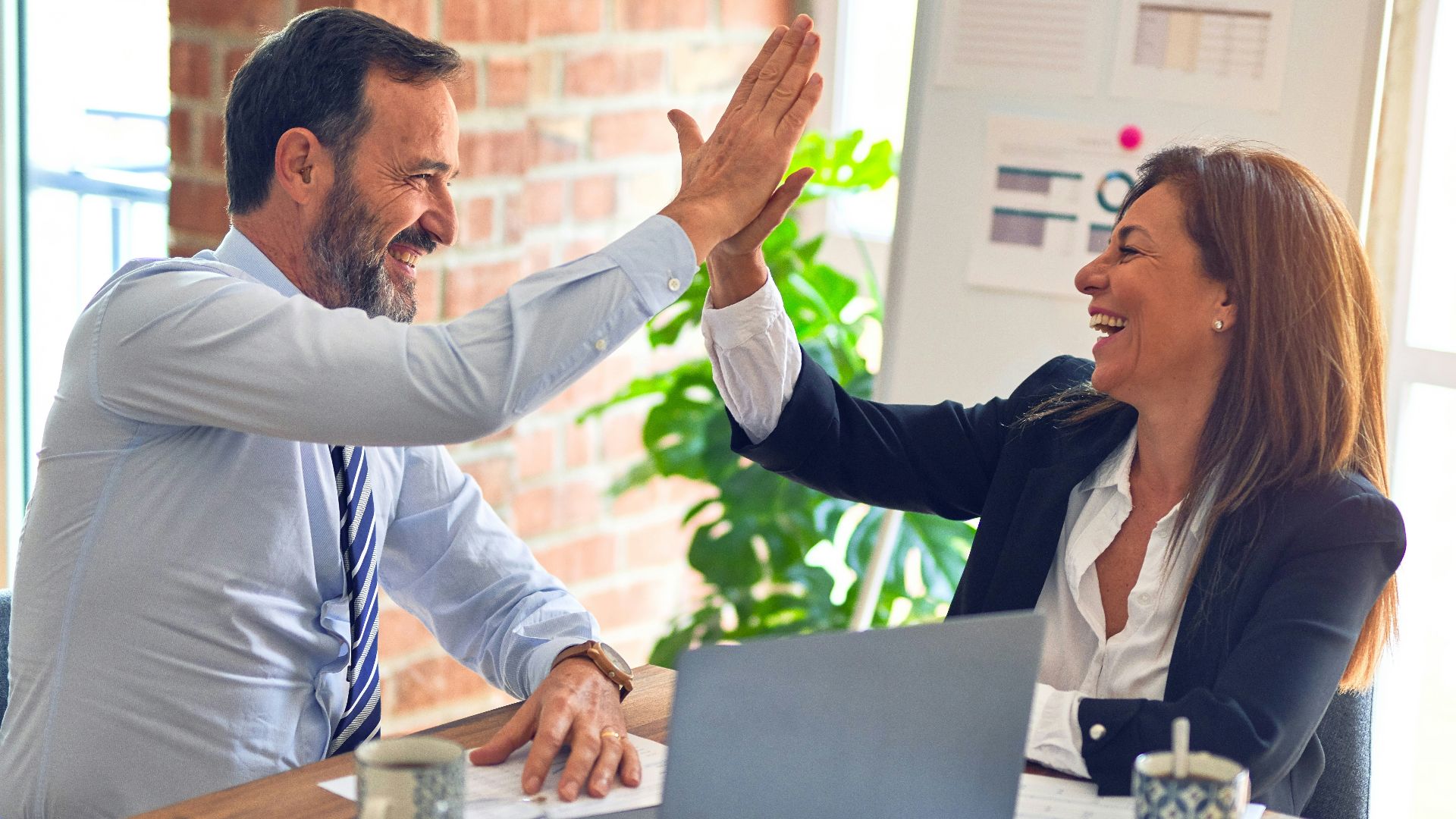 man in white dress shirt sitting beside woman in black long sleeve shirt