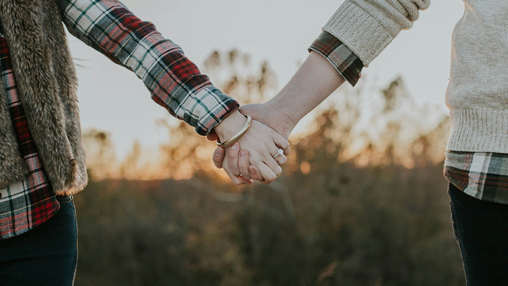 two person holding hands while standing