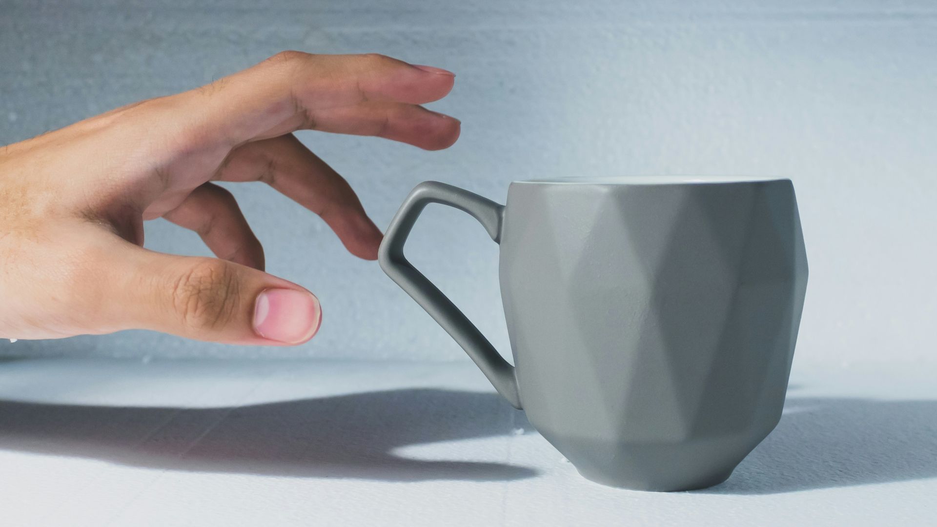 person holding white ceramic mug