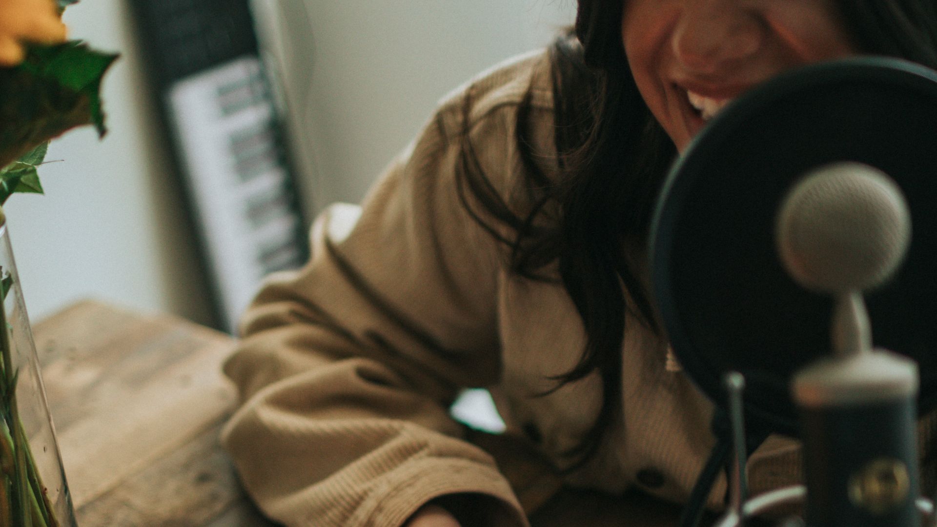 person in brown jacket using black smartphone
