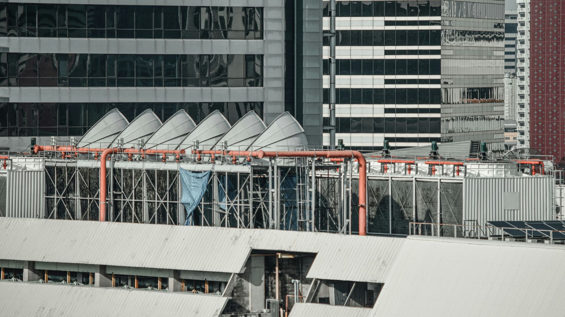 an airplane is flying over a city with tall buildings