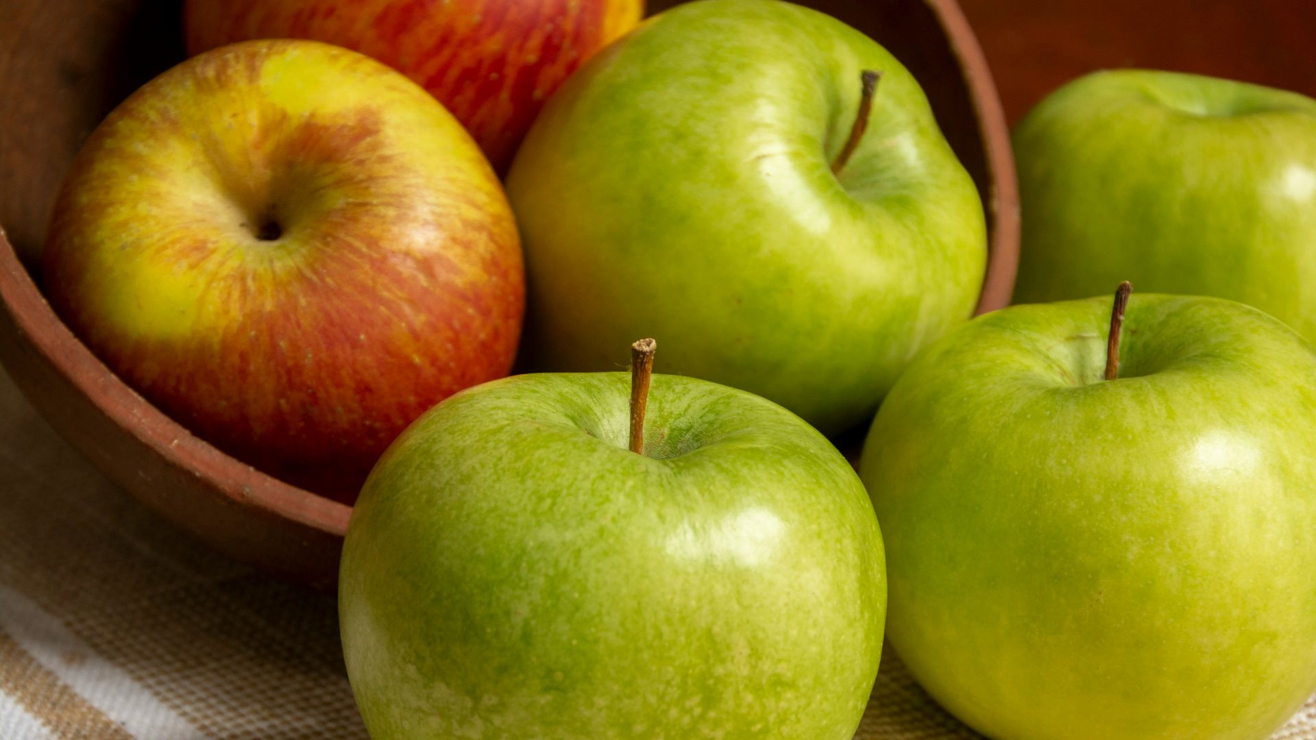 green apple on white table cloth
