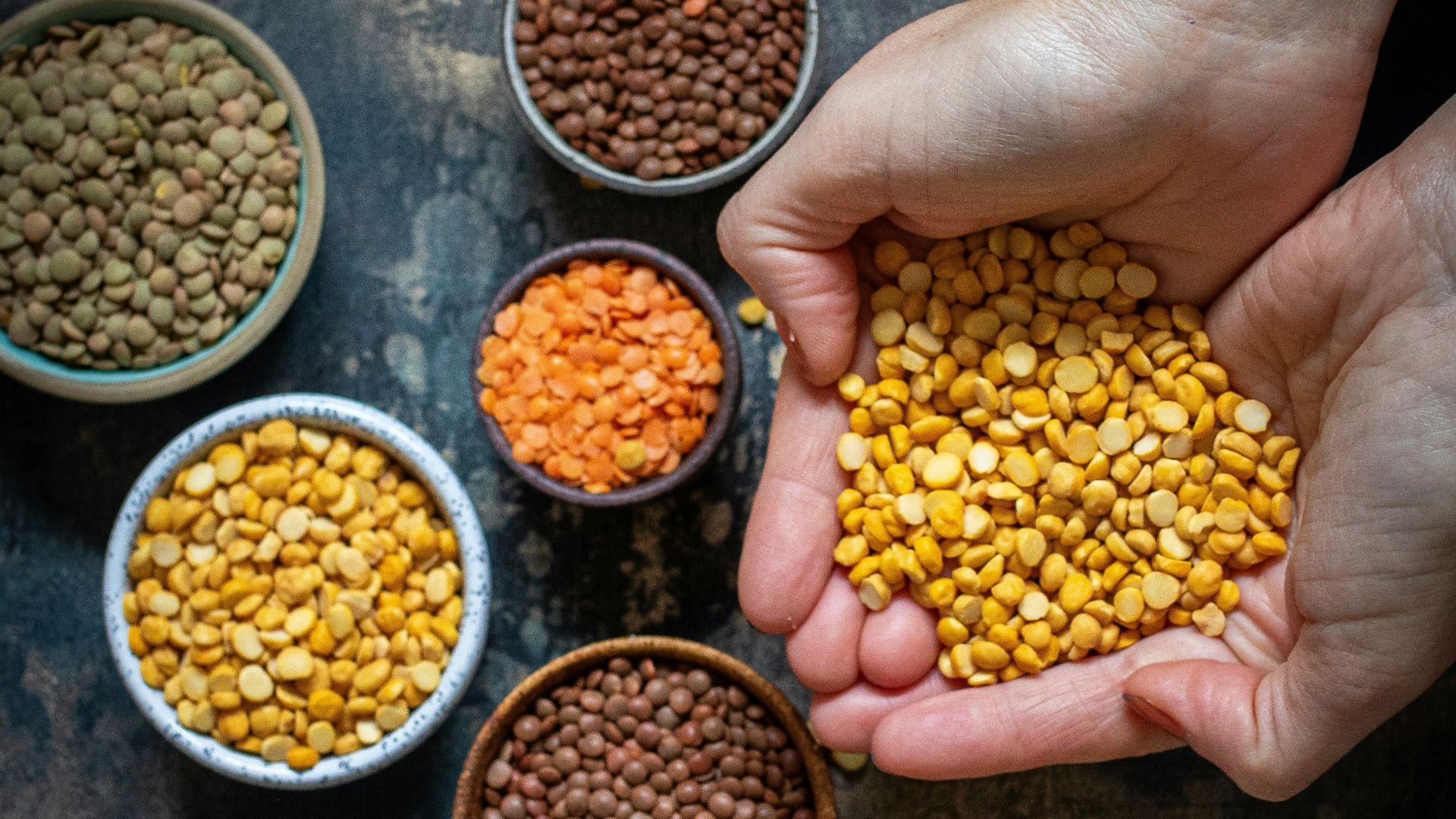 a person holding a handful of food in their hands