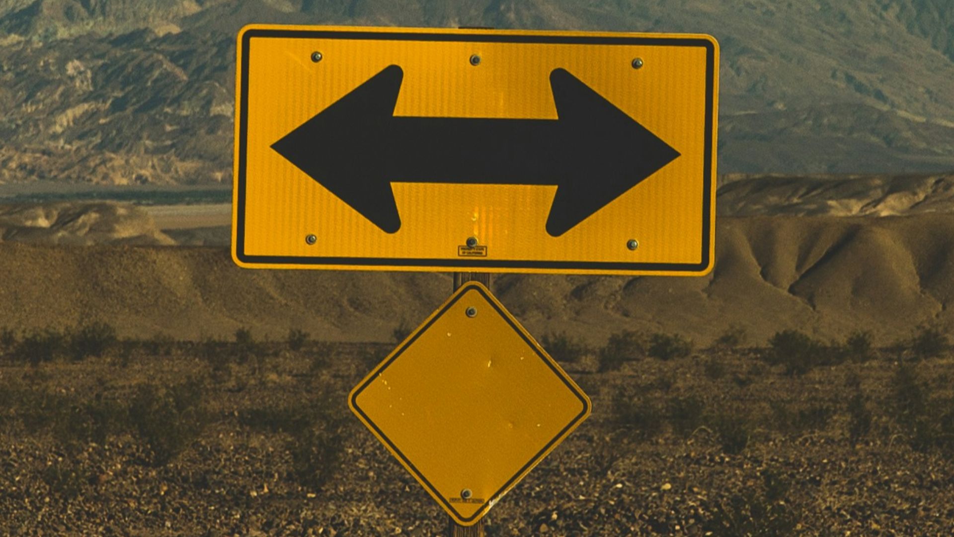 yellow arrow road sign