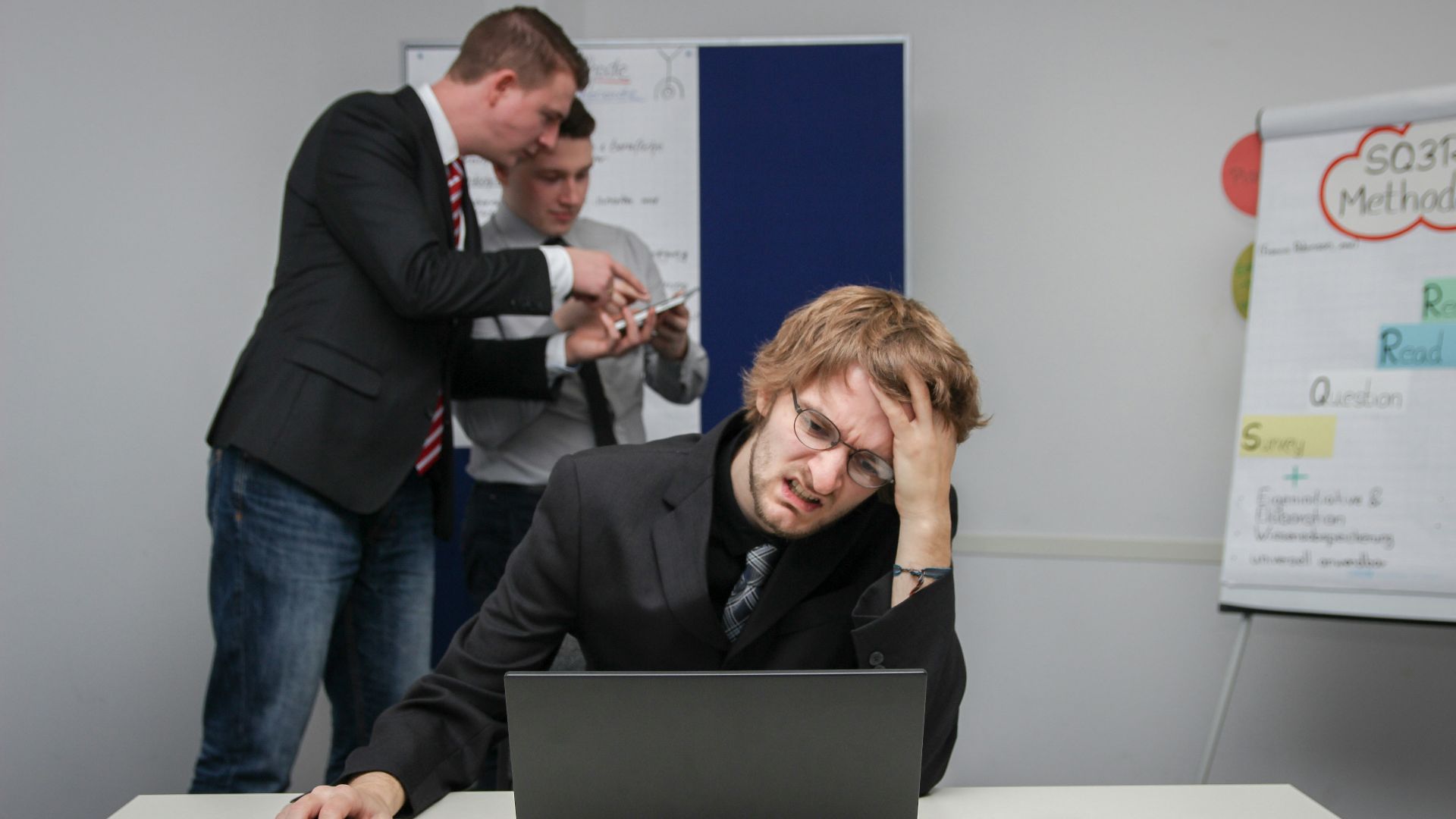 A man sitting in front of a laptop computer