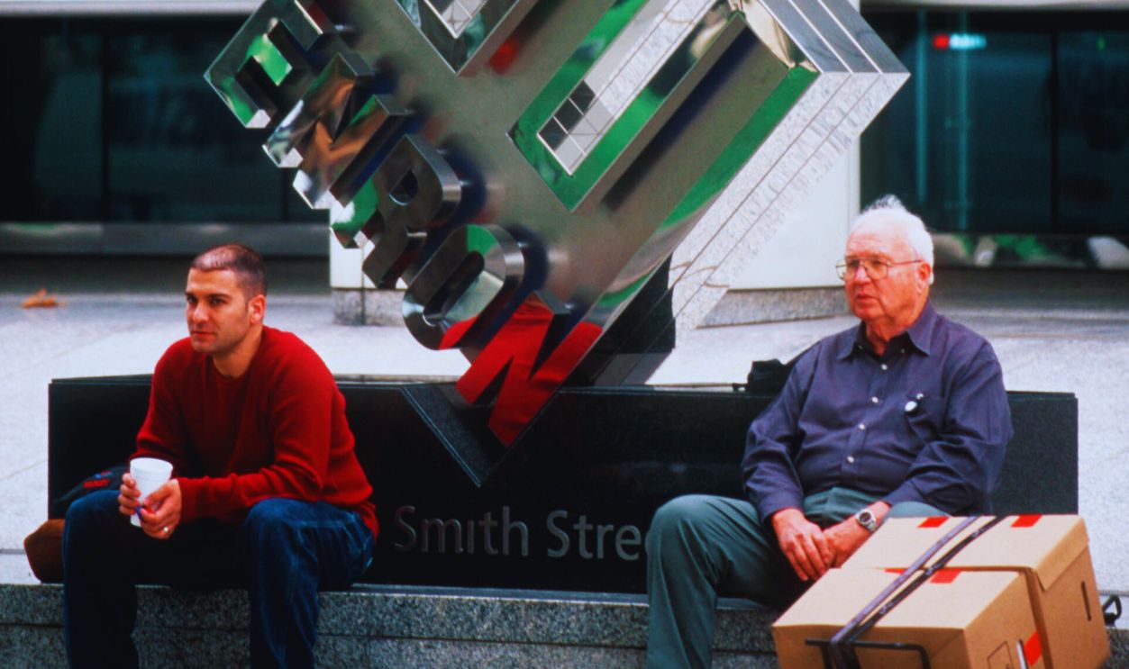 Gettyimages - 526768634, Enron layoffs Enron employees remove their belongings in boxes from Enron Headquarters after being laid off due to the collapse of the company.