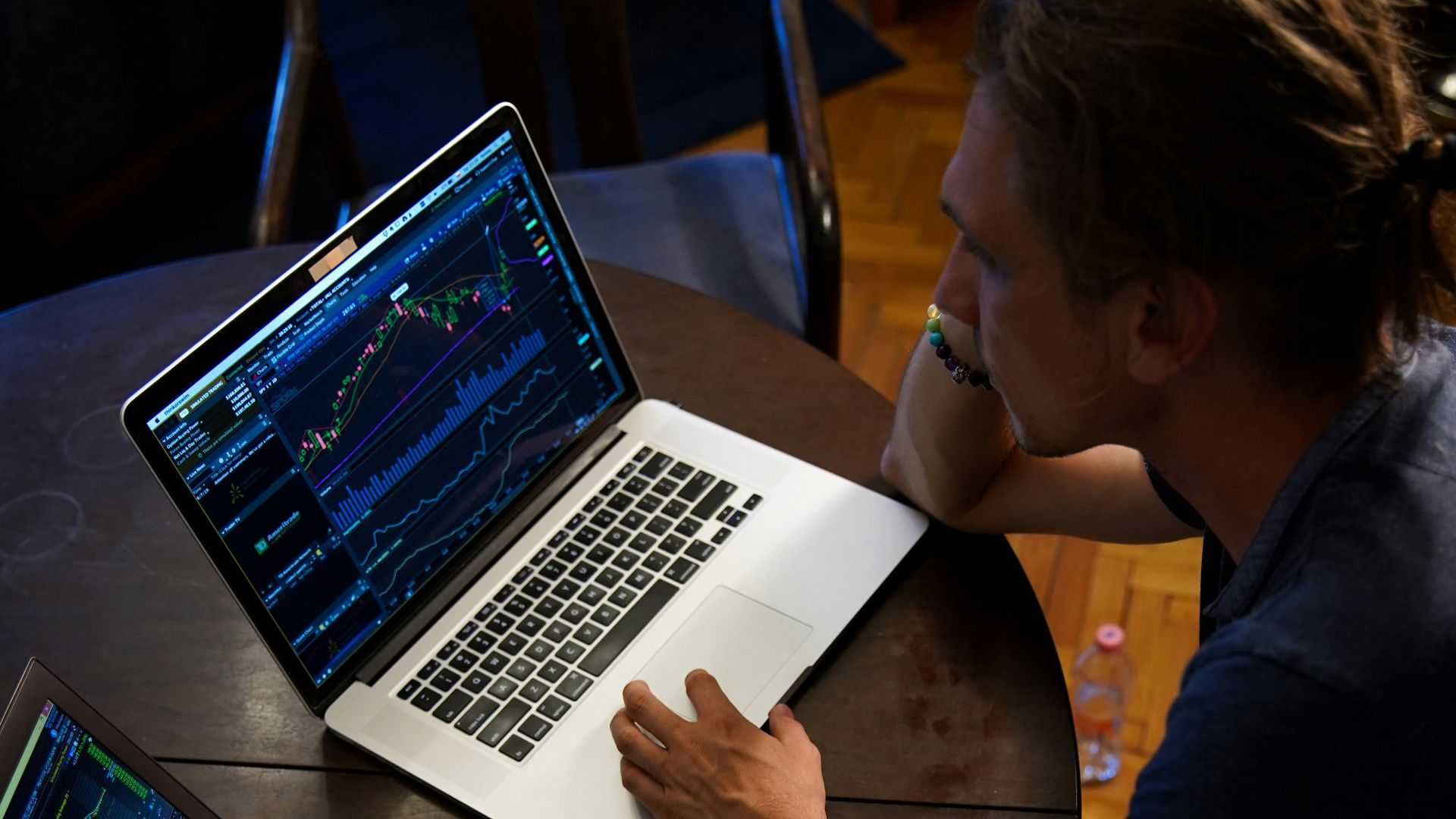 man sitting in front of the MacBook Pro