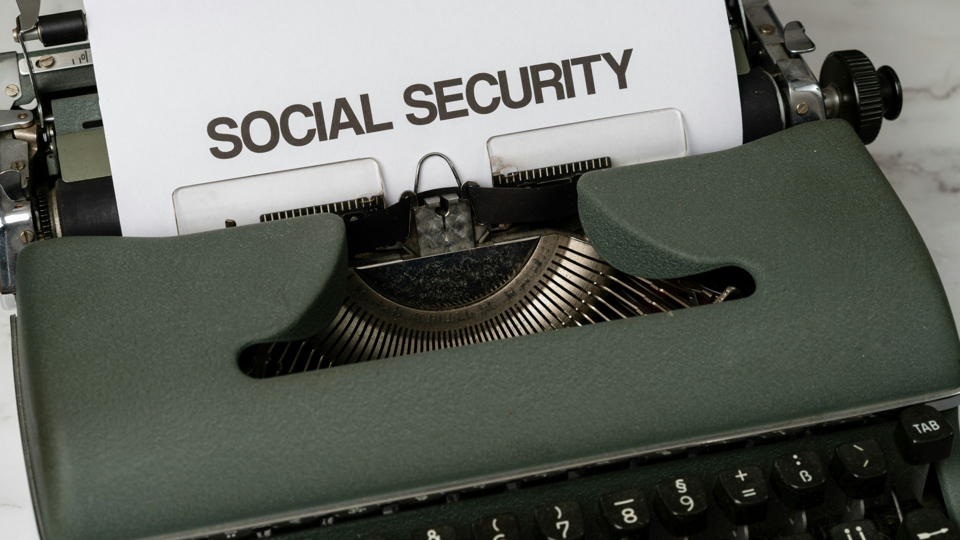a close up of a typewriter with a paper that says social security