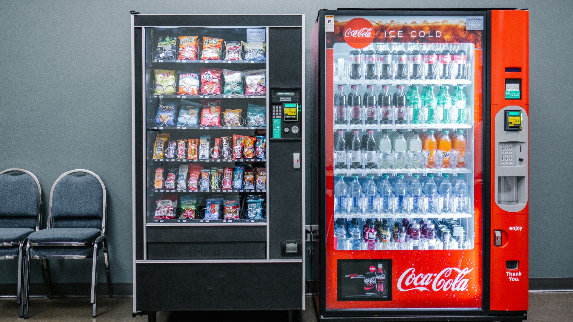 coca cola and coca cola bottles in black vending machine