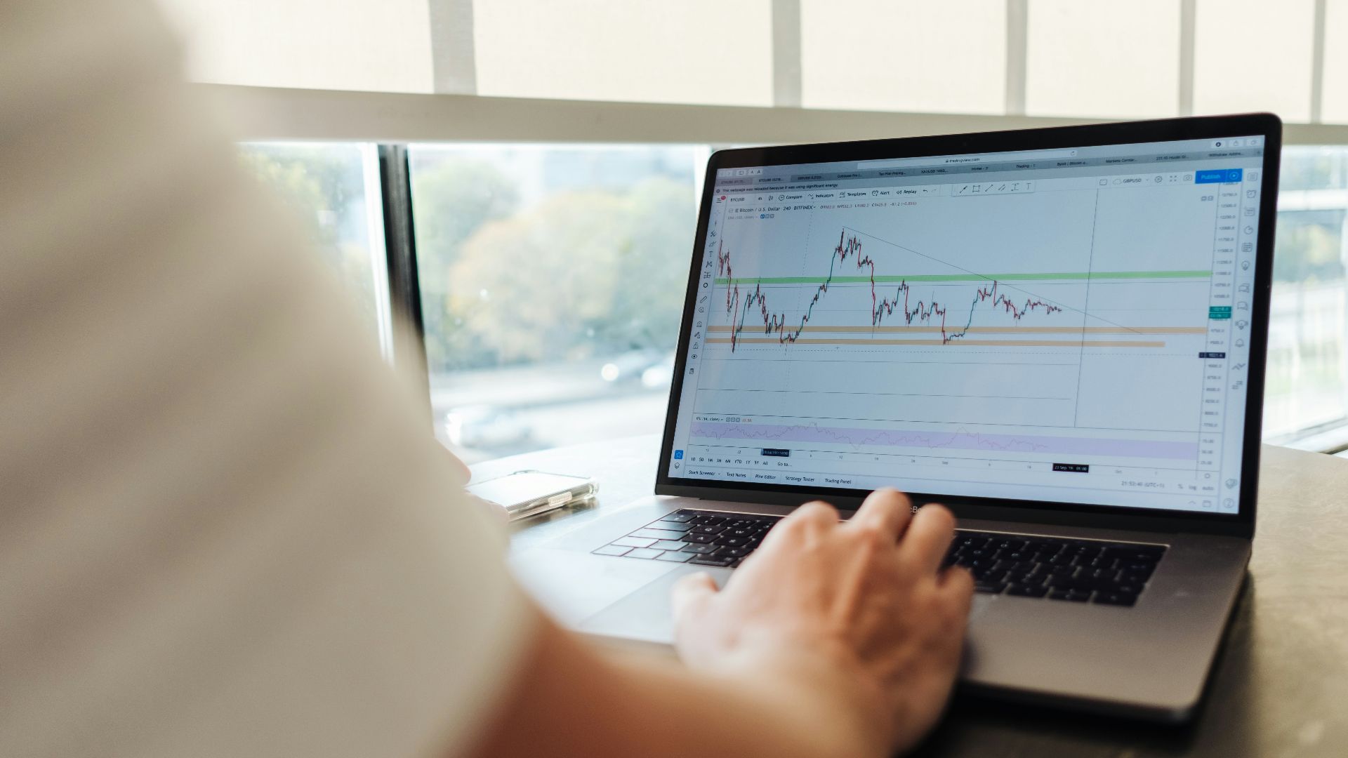 person using MacBook Pro on table