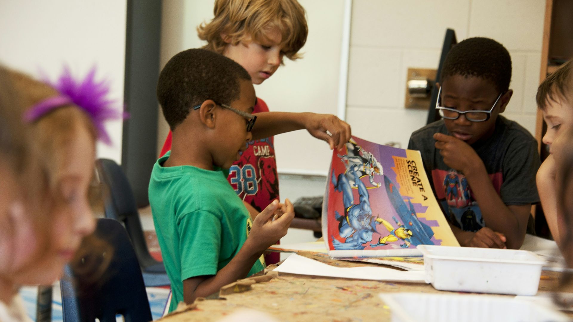 boy in red crew neck t-shirt sitting beside boy in blue crew neck t-shirt
