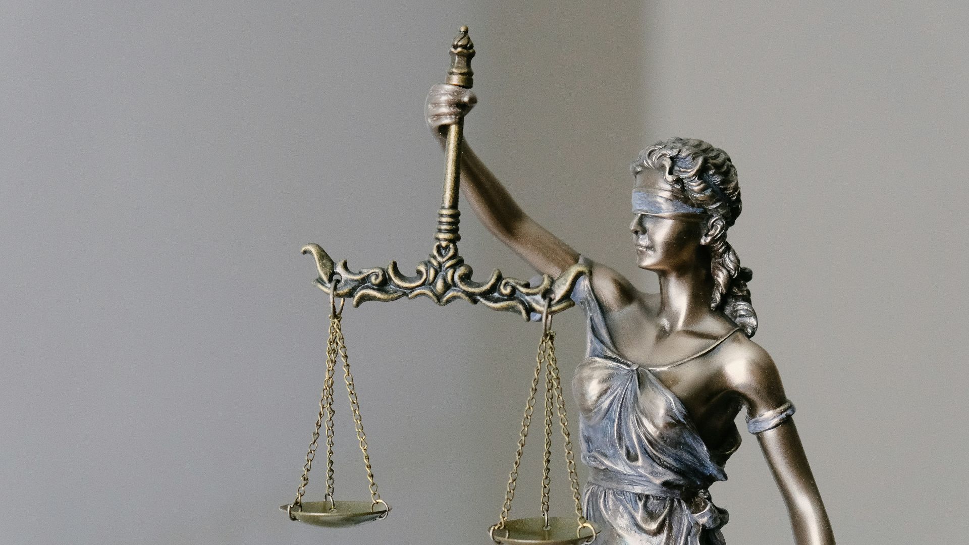 woman in dress holding sword figurine