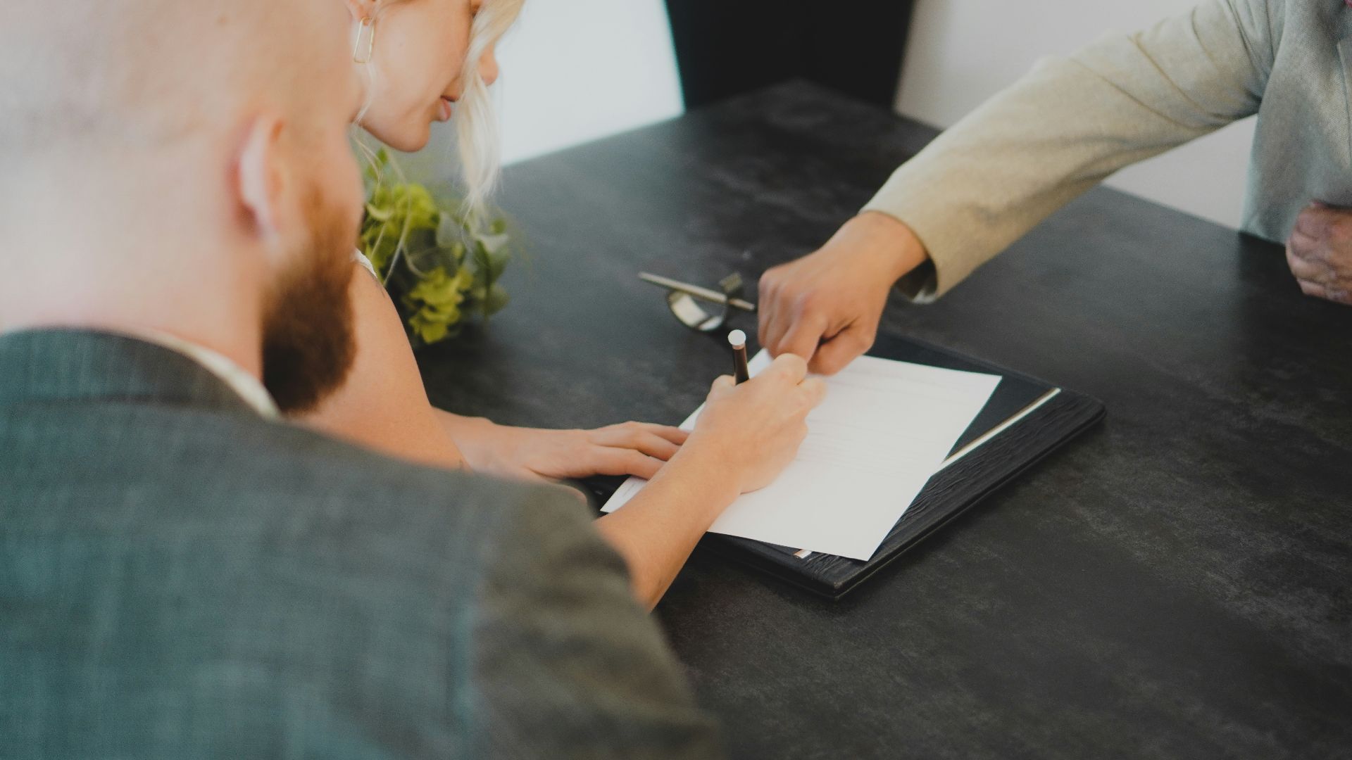 a woman showing a man something on a tablet