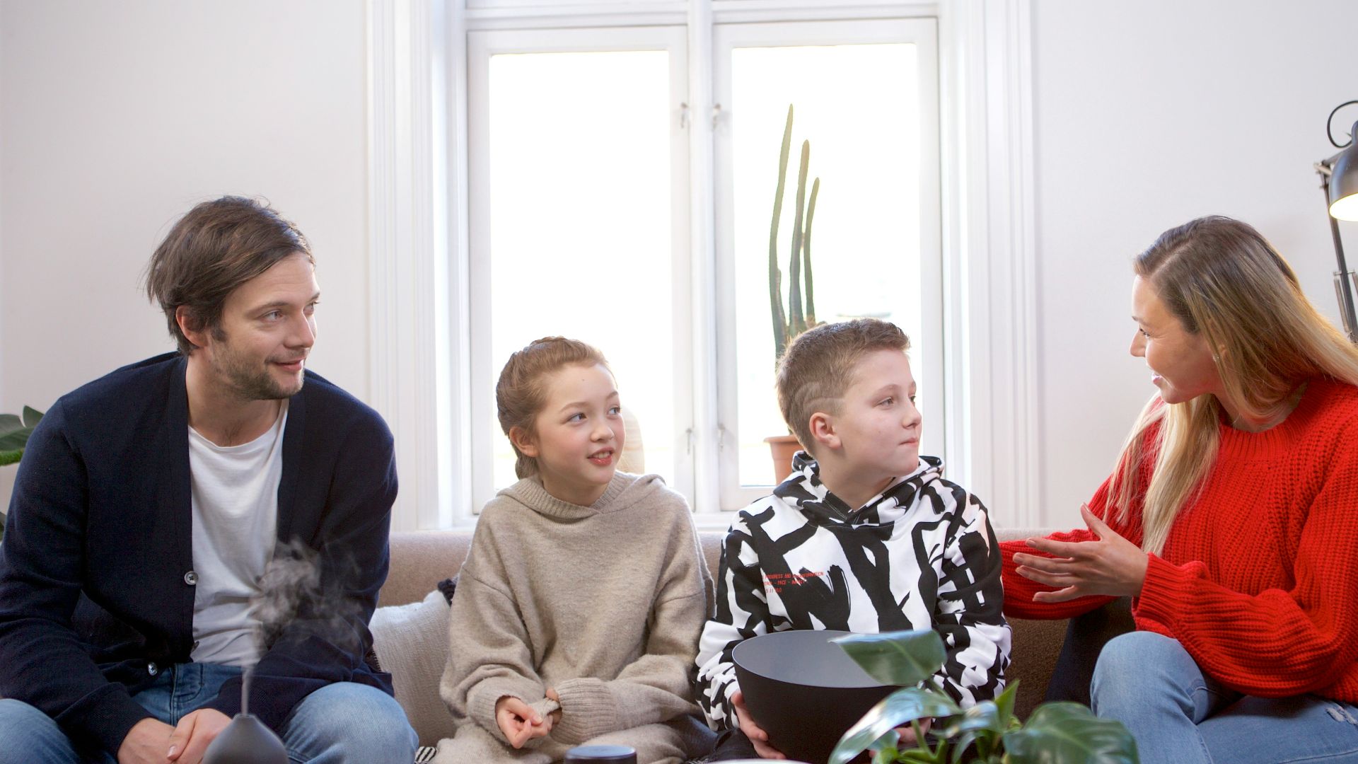 a group of people sitting on top of a couch