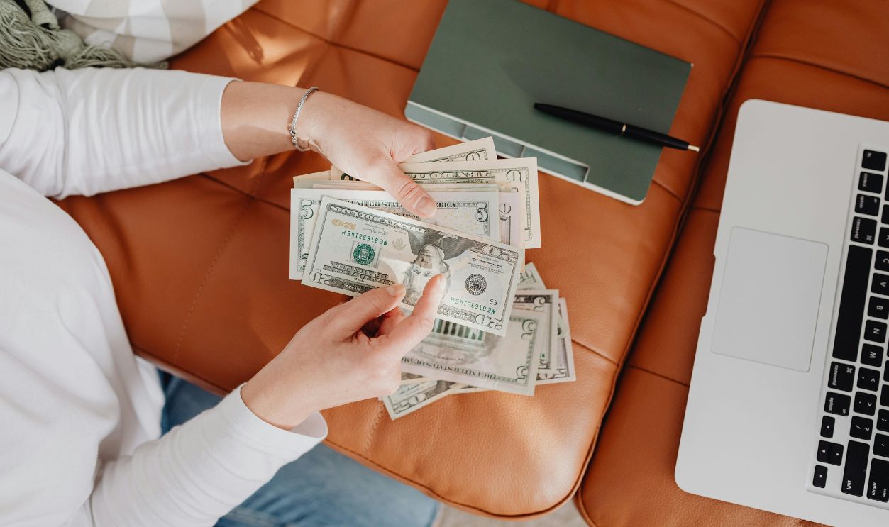 Woman counting dollar bills