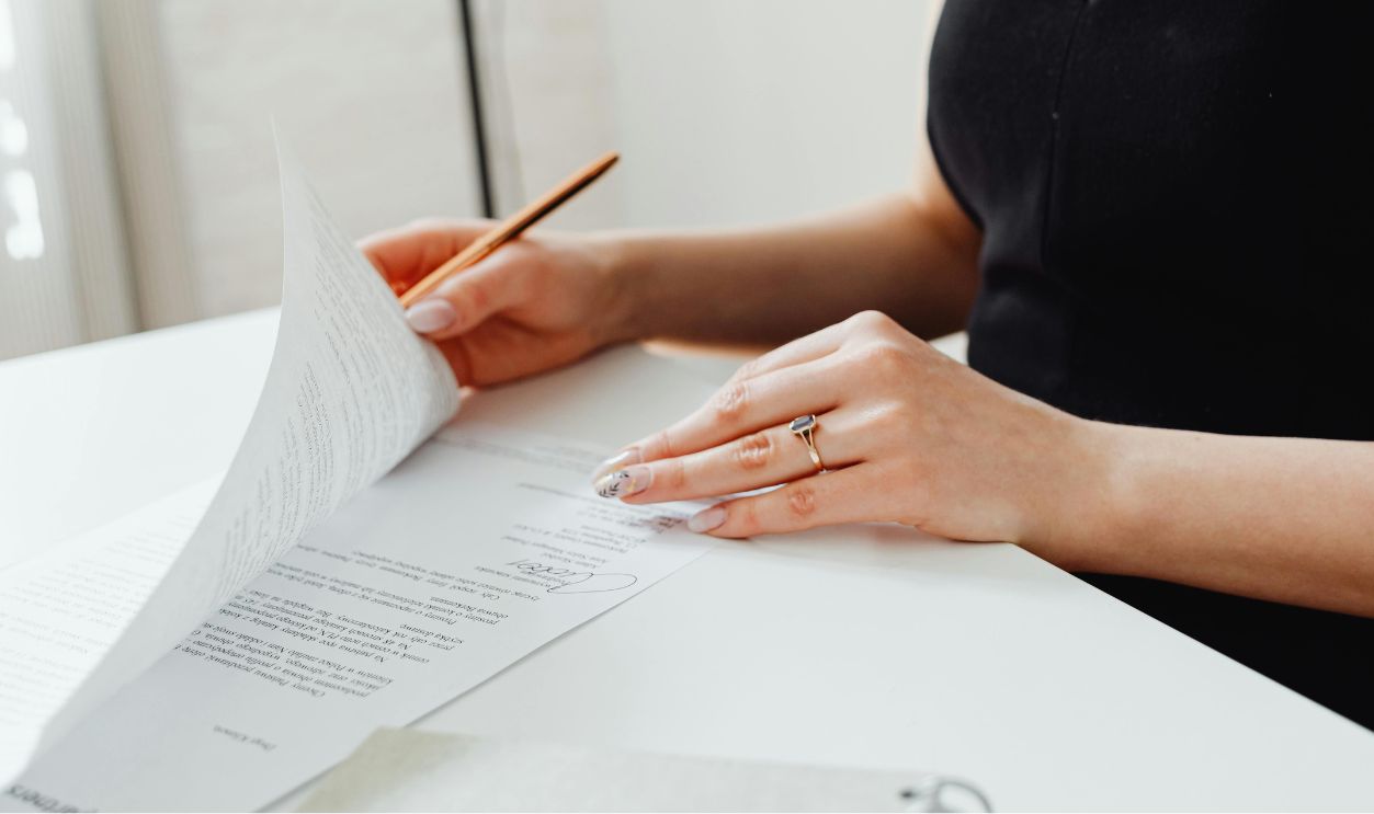 Woman in black top holding papers