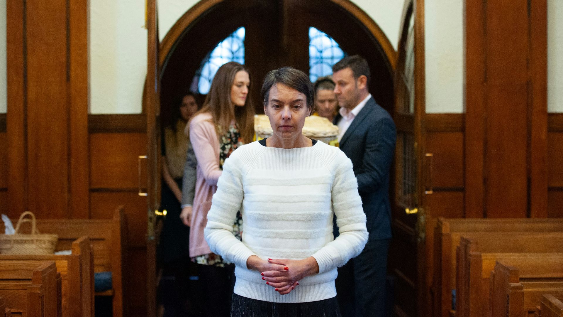a woman standing in front of a group of people