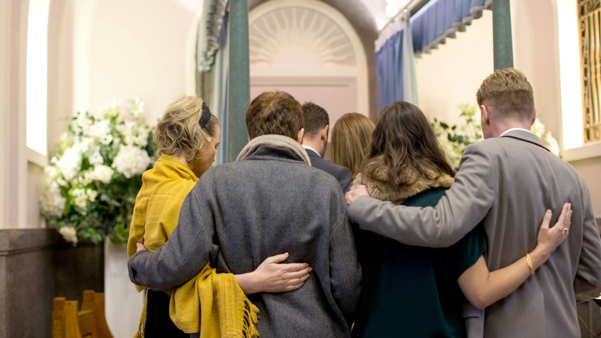 a group of people standing in front of a doorway